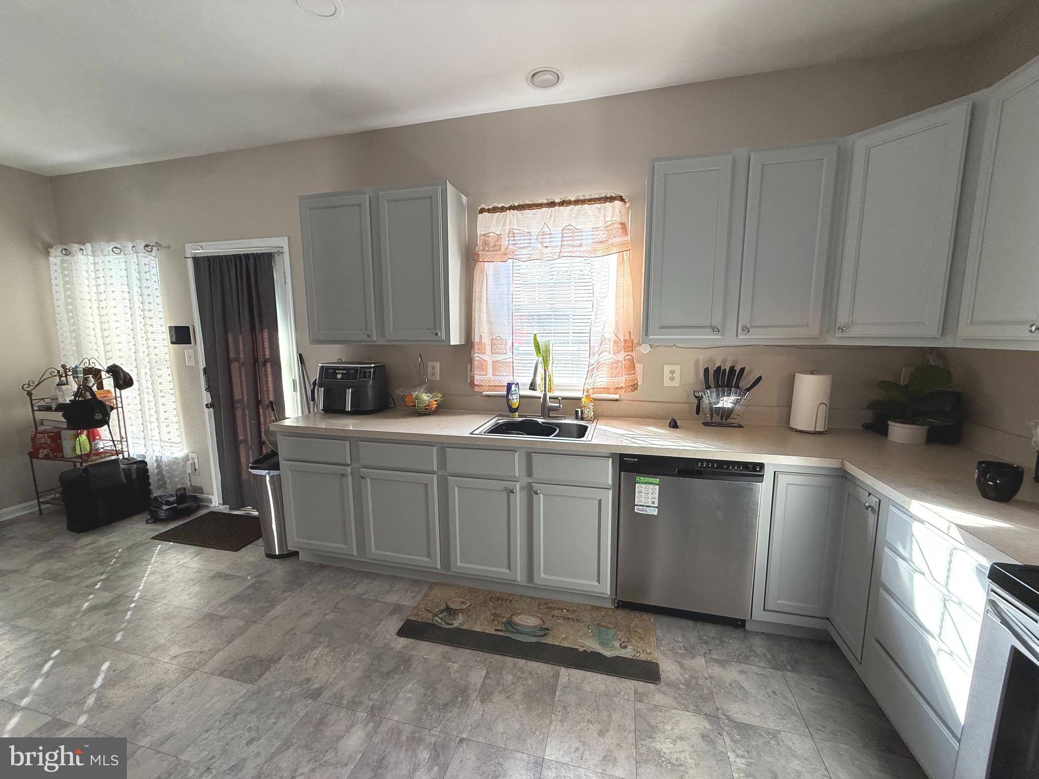 215 Seamaster Road Essex, MD 21221 - Photo 5 of 34 a kitchen with a sink cabinets and window