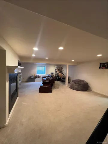 a large room with furniture and a fireplace