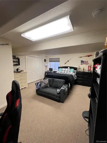 a living room with furniture gym equipment and a vanity