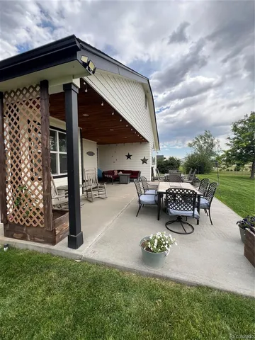 a backyard of a house with yard barbeque oven and outdoor seating