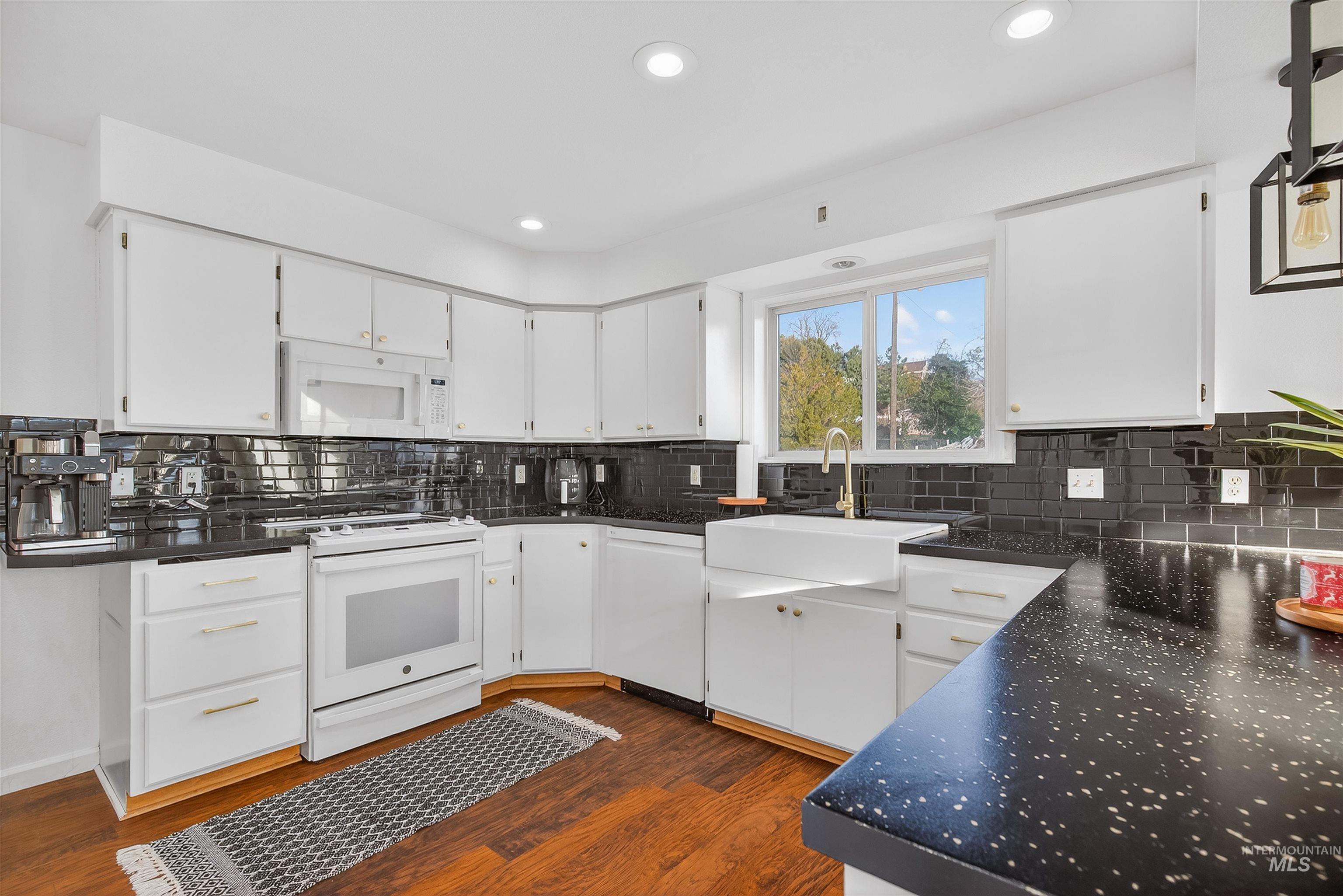 822 15th Avenue Lewiston, ID 83501 - Photo 15 of 44 Kitchen with white cabinets, white appliances, dark wood-type flooring, recessed lighting, and dark stone counters