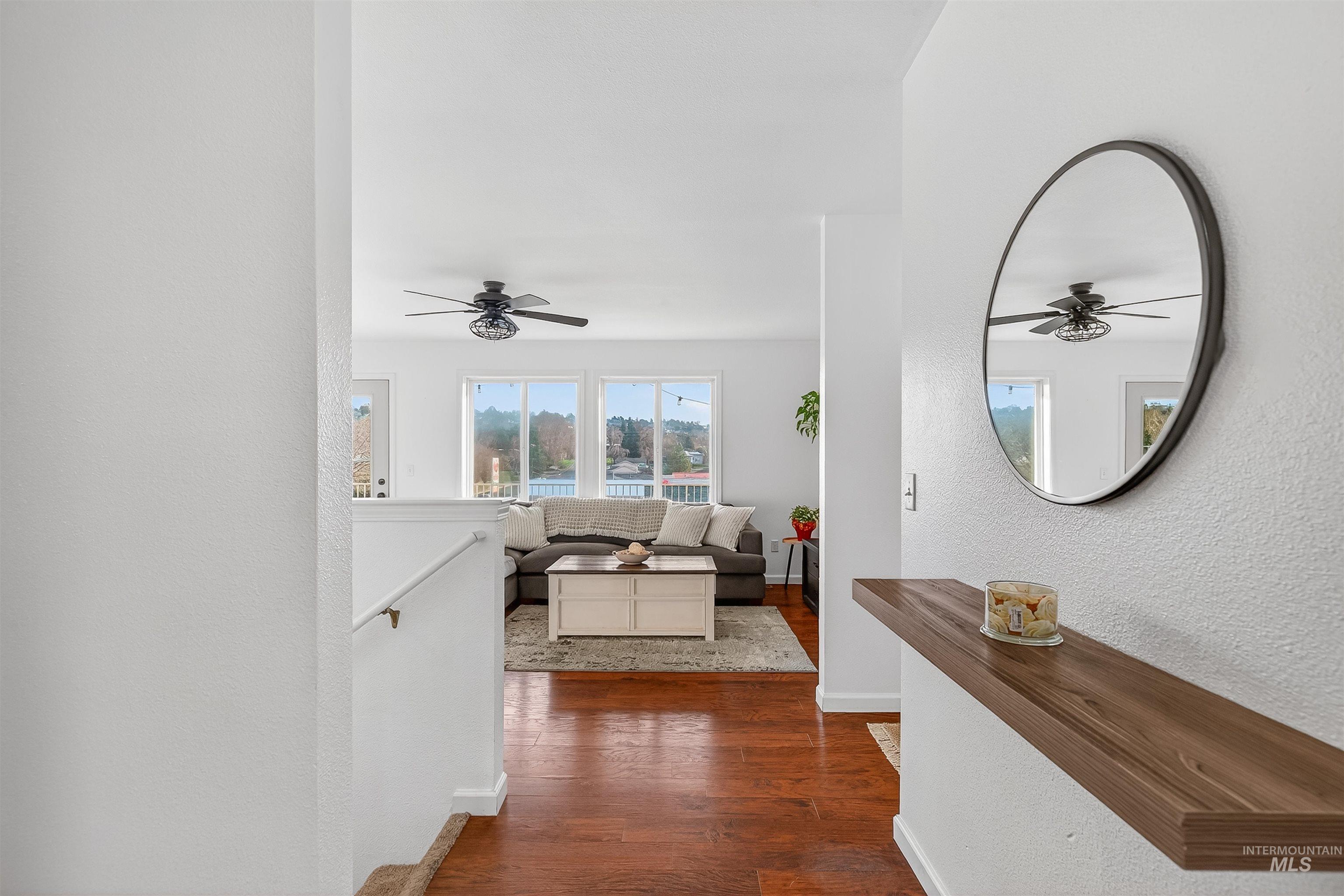 822 15th Avenue Lewiston, ID 83501 - Photo 3 of 44 Hallway featuring dark wood finished floors, an upstairs landing, and a textured wall