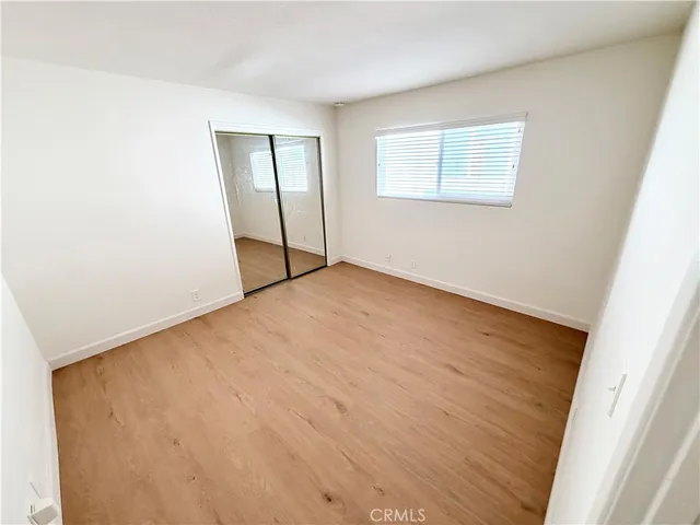 an empty room with windows and closet