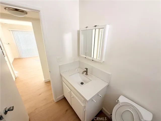 a bathroom with a sink a toilet and mirror