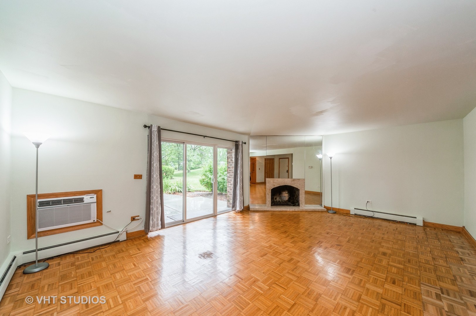 10357 Dearlove Road, Unit 1F Glenview, IL 60025 - Photo 2 of 15 a view of an empty room with a fireplace and a window