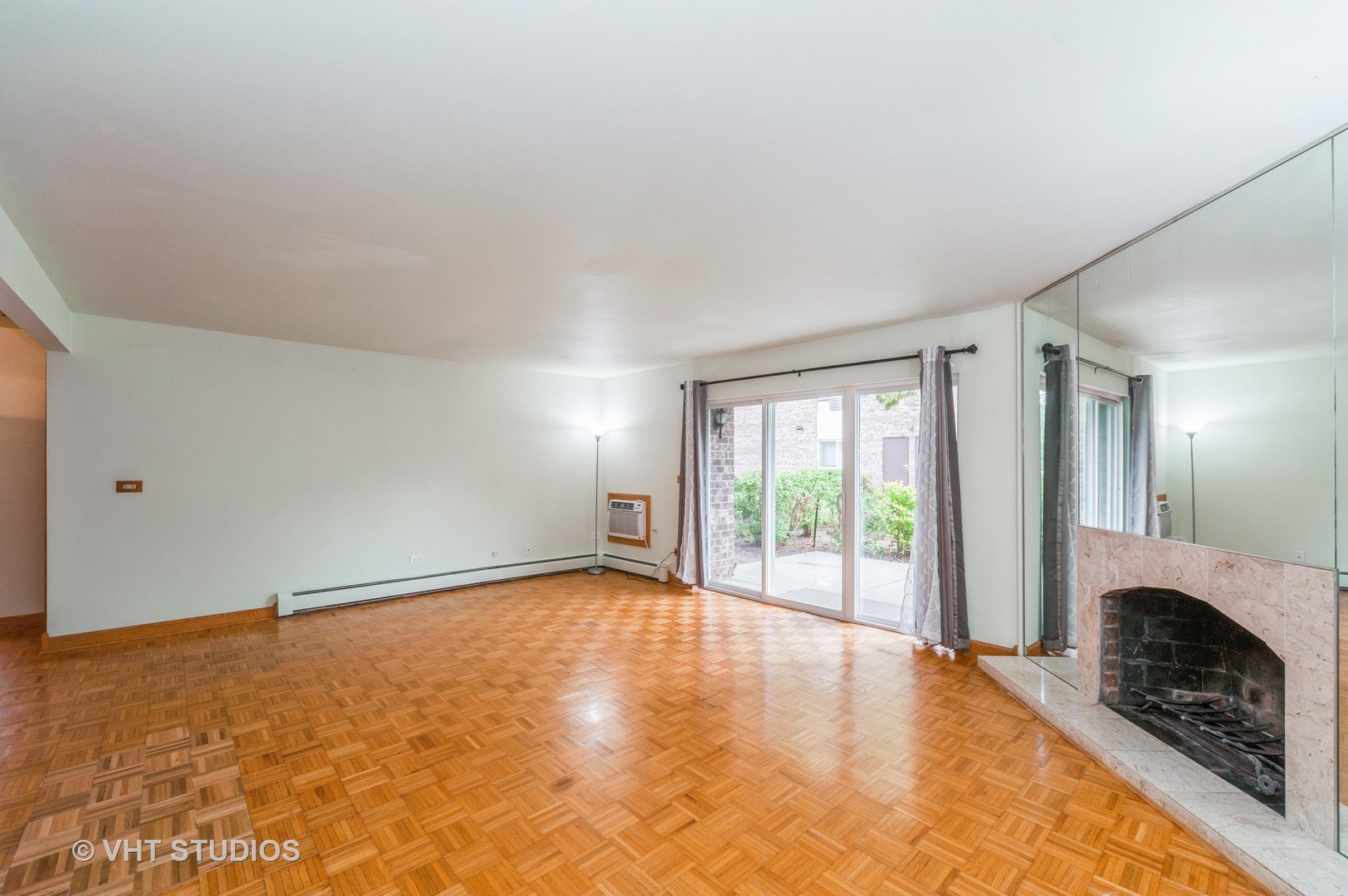 10357 Dearlove Road, Unit 1F Glenview, IL 60025 - Photo 6 of 15 a view of an empty room with a fireplace and a window
