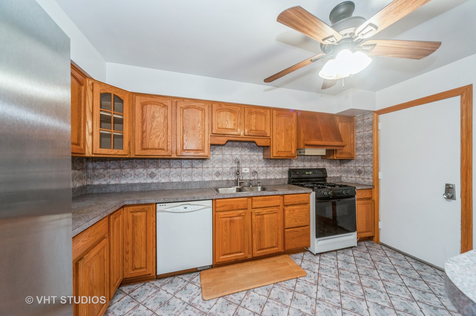 10357 Dearlove Road, Unit 1F Glenview, IL 60025 - Photo 7 of 15 a kitchen with stainless steel appliances granite countertop a stove sink and cabinets