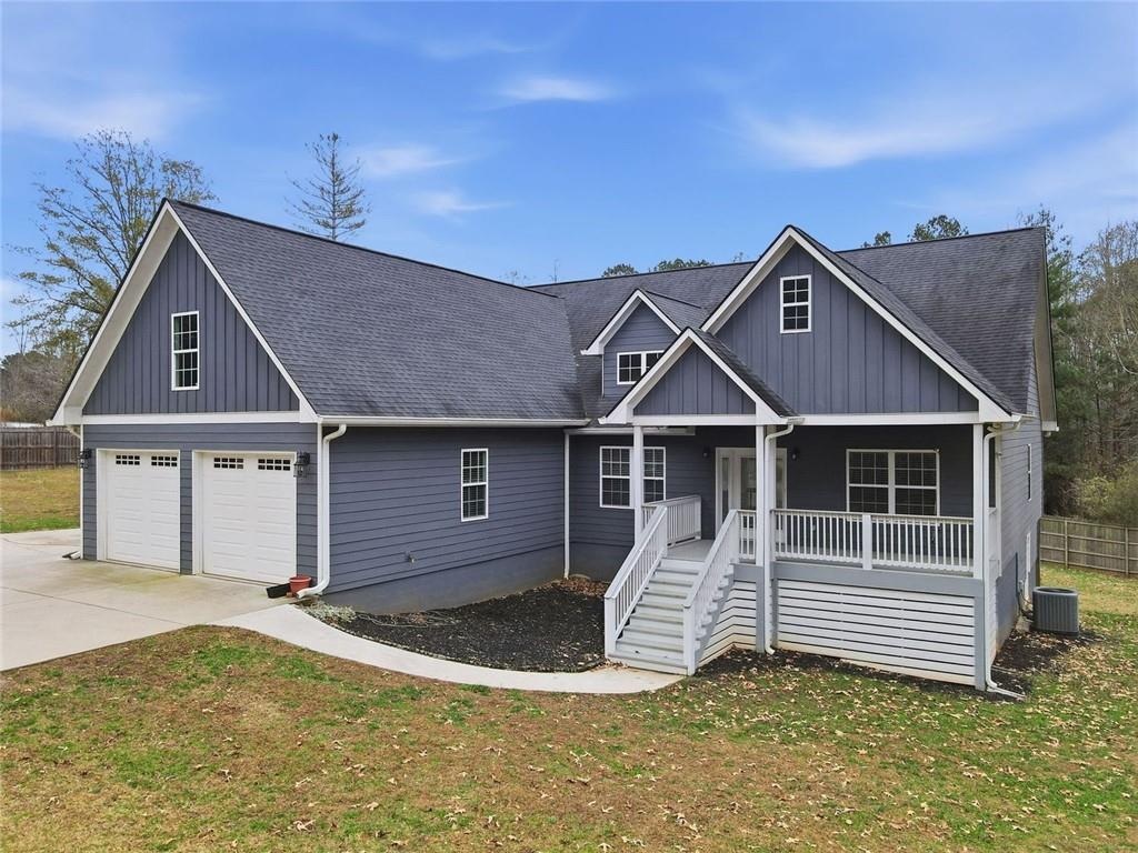 1006 Owens Store Road Canton, GA 30115 - Photo 2 of 48 a front view of a house with a yard