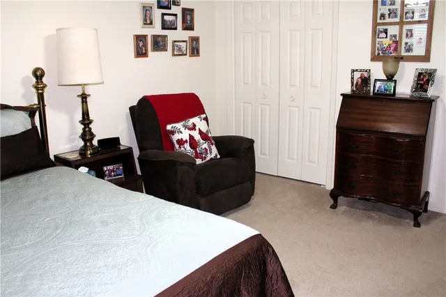 a bedroom with a bed and a couch