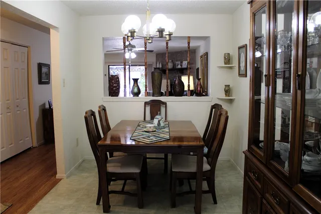 a view of a dining room with furniture and chandelier