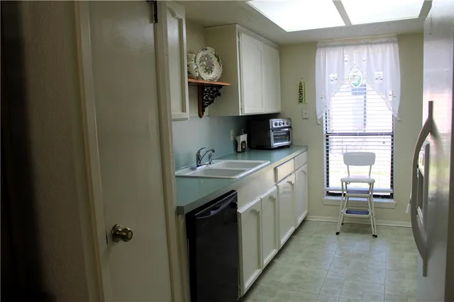 a kitchen with sink cabinets and window