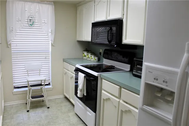 a kitchen with a stove and a microwave