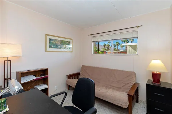 a view of balcony with chairs and wooden fence