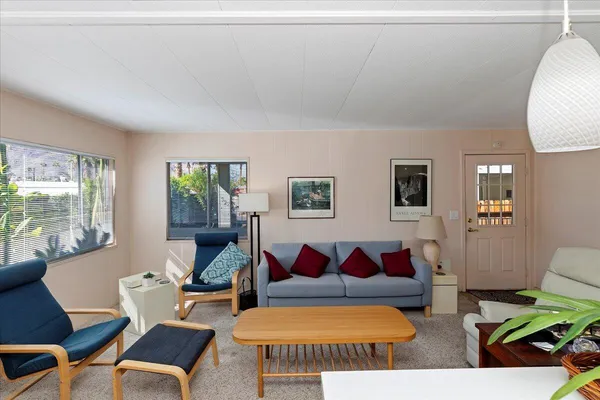 a living room with furniture a rug and a window