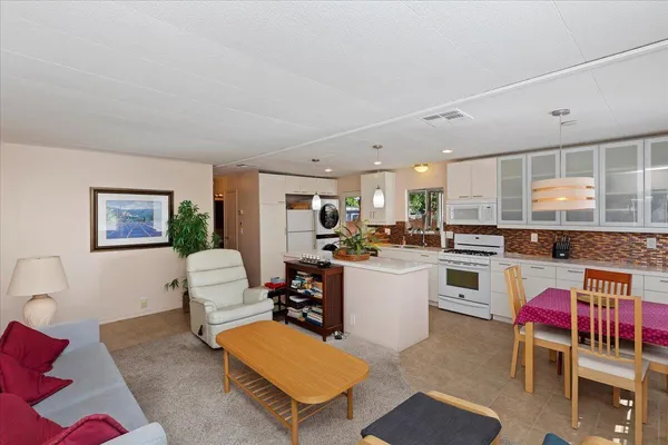 a kitchen with stainless steel appliances kitchen island granite countertop a sink and cabinets