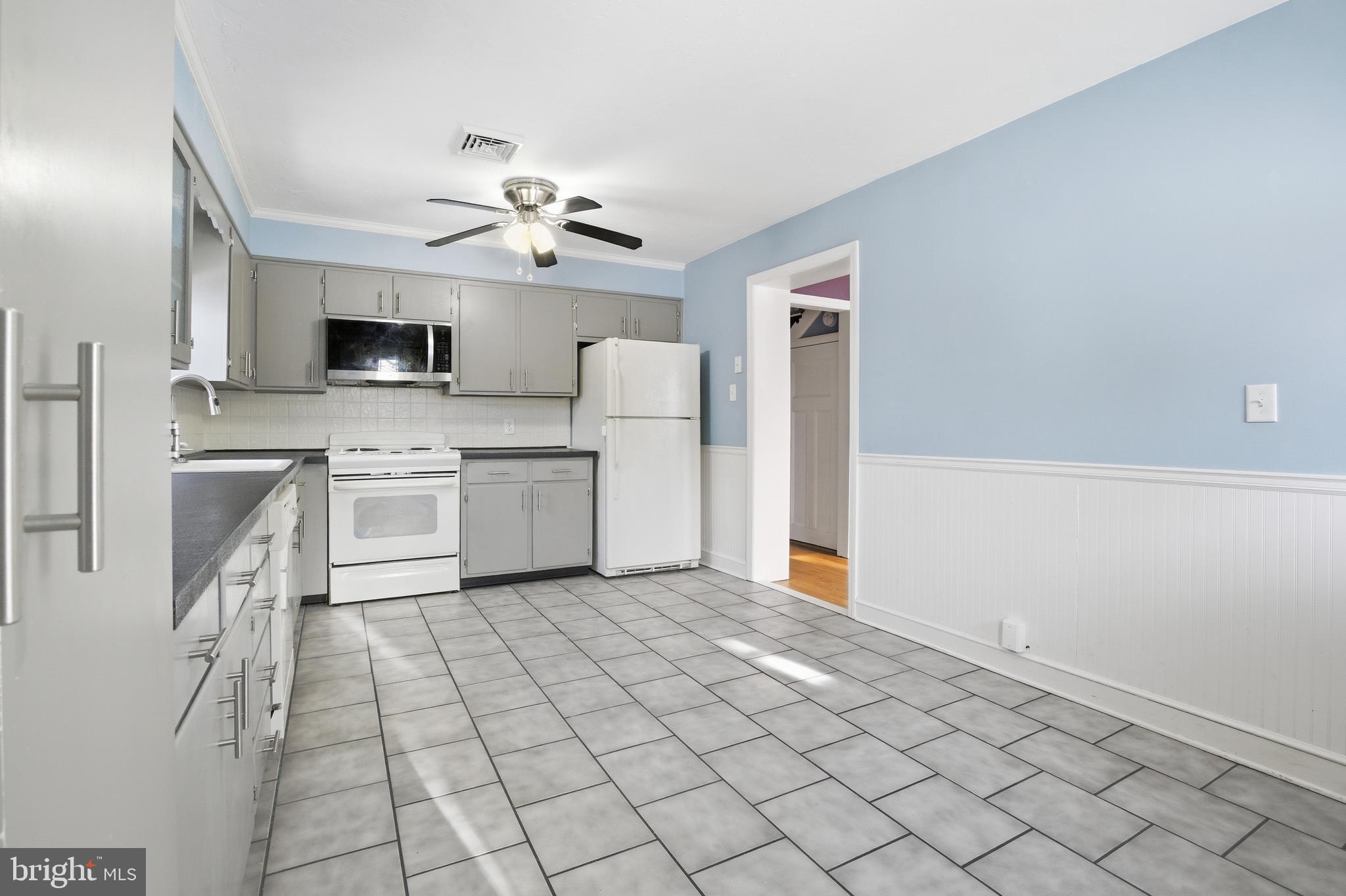 68 Maple Avenue Littlestown, PA 17340 - Photo 14 of 37 a view of a kitchen with microwave and a stove top oven