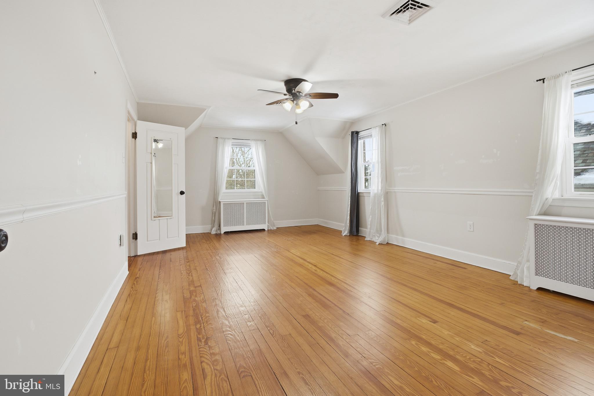 68 Maple Avenue Littlestown, PA 17340 - Photo 15 of 37 an empty room with wooden floor ceiling fan and windows