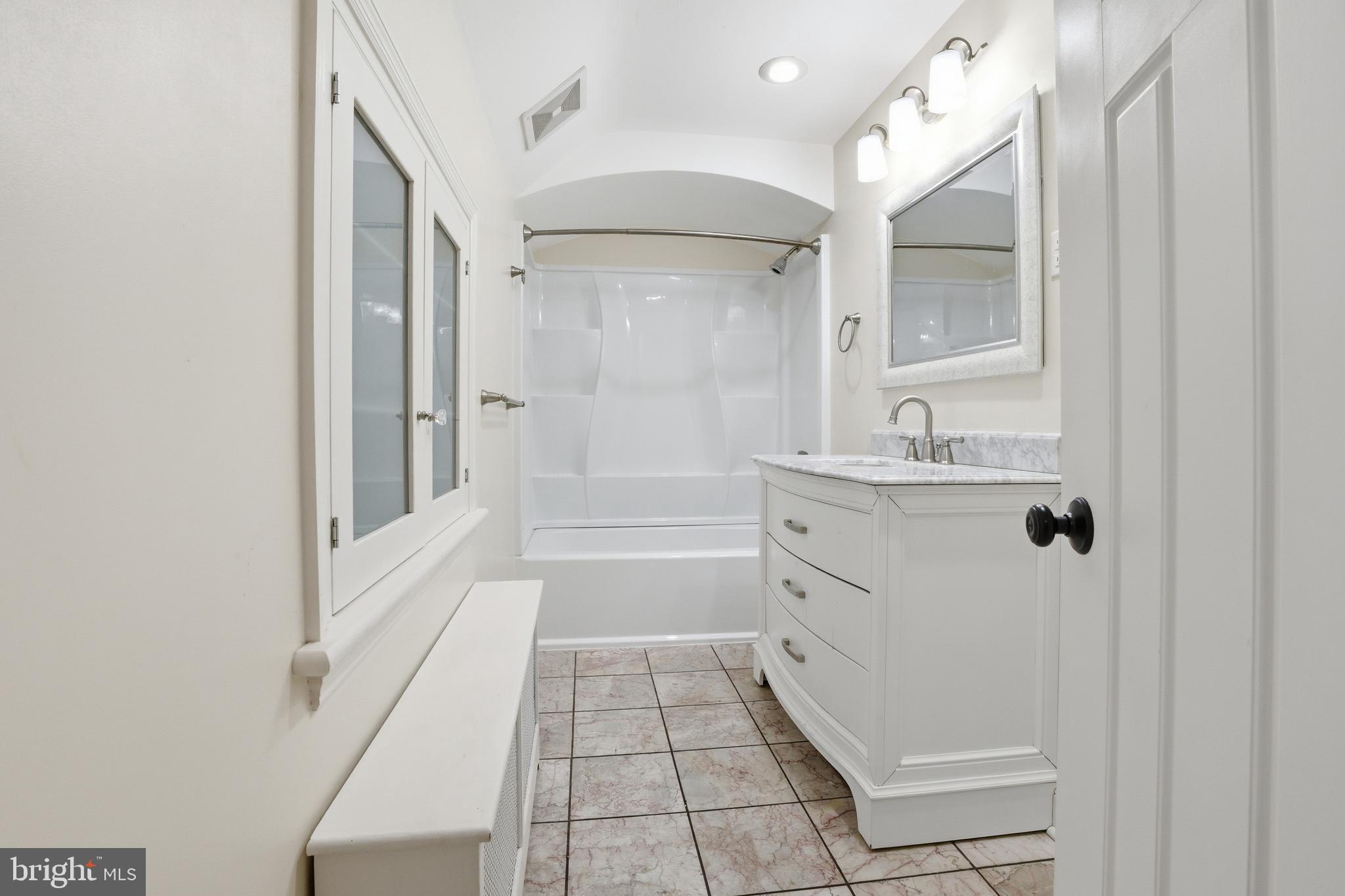 68 Maple Avenue Littlestown, PA 17340 - Photo 19 of 37 a bathroom with a sink a mirror and a bathtub