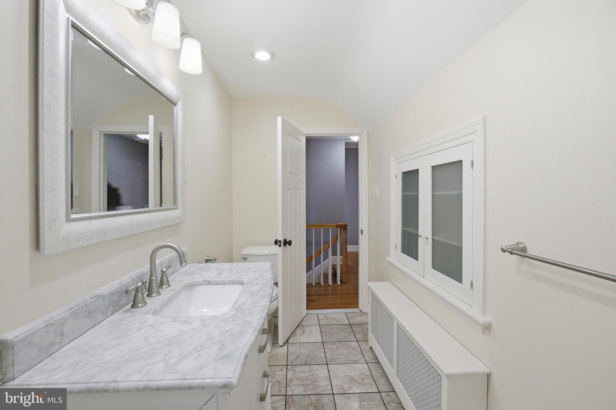 68 Maple Avenue Littlestown, PA 17340 - Photo 20 of 37 a bathroom with a granite countertop sink and a mirror