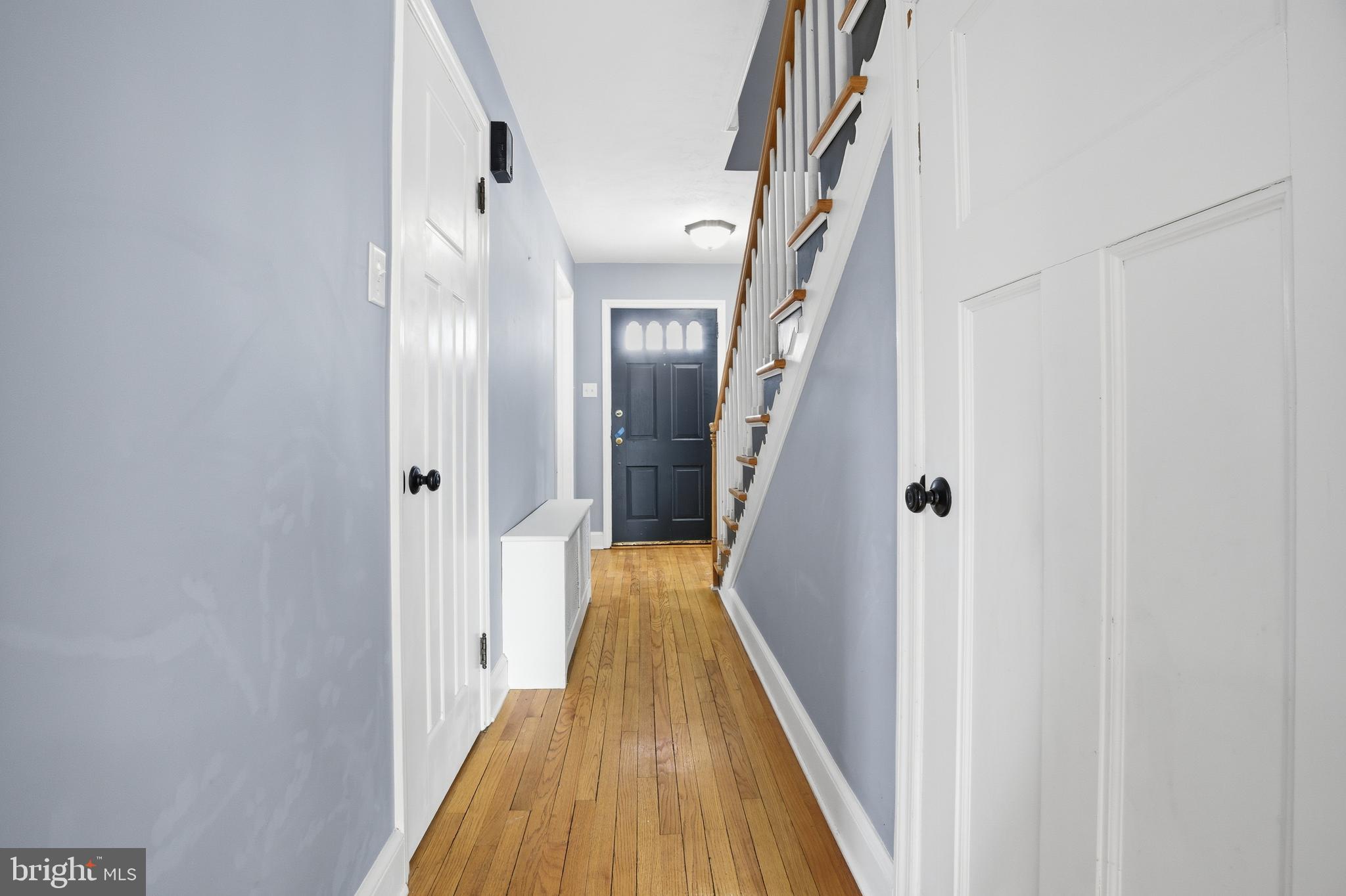 68 Maple Avenue Littlestown, PA 17340 - Photo 6 of 37 a view of a hallway with wooden floor and staircase