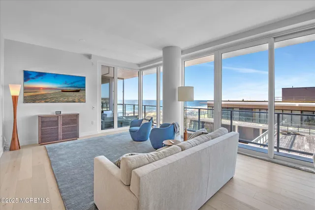 a kitchen with stainless steel appliances granite countertop a stove a refrigerator a microwave oven with white cabinets and island