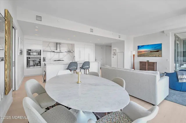 a large white kitchen with a large window