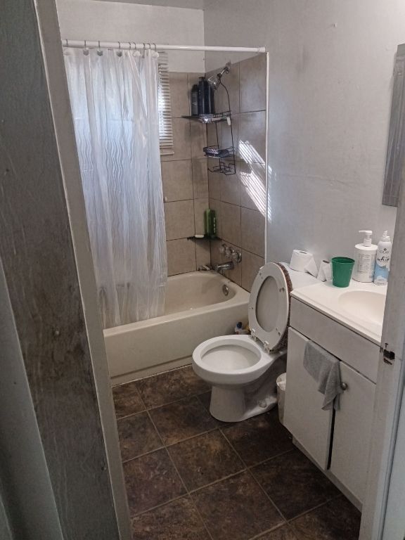 3208 East 16th Street Austin, TX 78721 - Photo 4 of 5 Full bathroom featuring toilet, vanity, and shower / tub combo with curtain