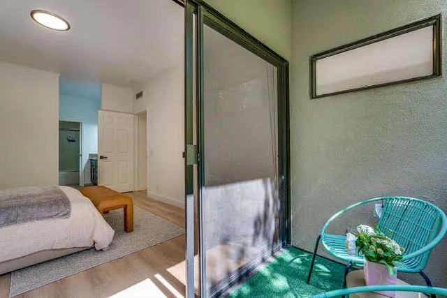 a bedroom with a bed and a potted plant