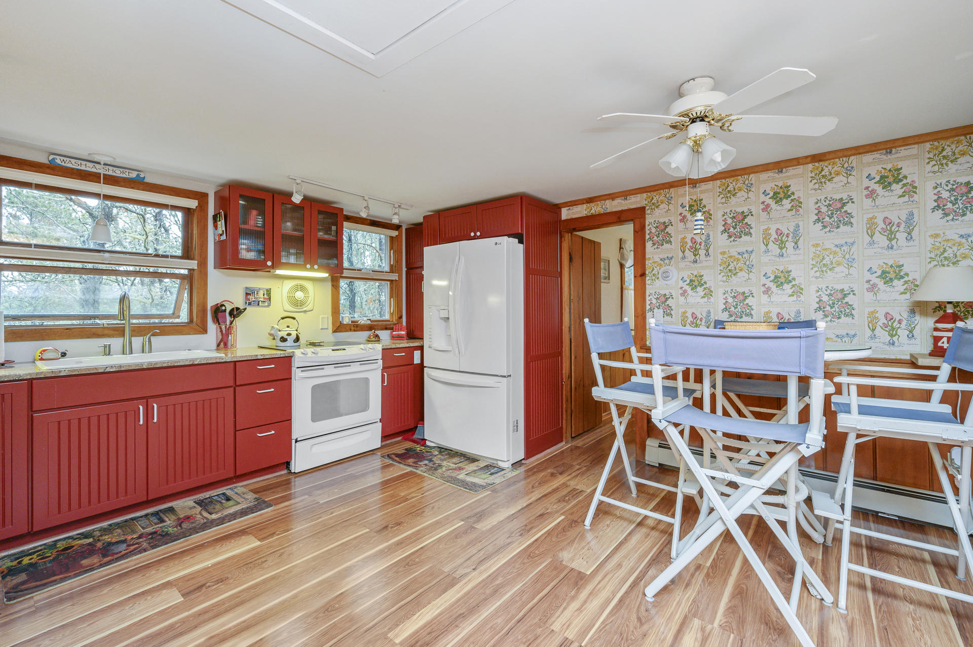 88 Deep Hole Road Harwich Port, MA 02646 - Photo 8 of 30 a kitchen with stainless steel appliances granite countertop a stove top oven a dining table and chairs with wooden floor