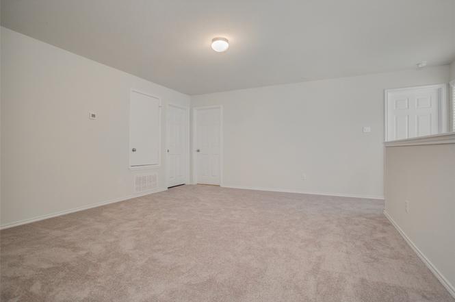 148 Spotted Rail Ridge Leander, TX 78641 - Photo 19 of 31 A spacious, neutral room offers flexible living arrangements, perfect for any design vision.
