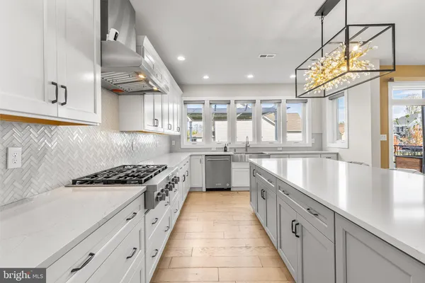 a large kitchen with stainless steel appliances granite countertop a lot of counter space