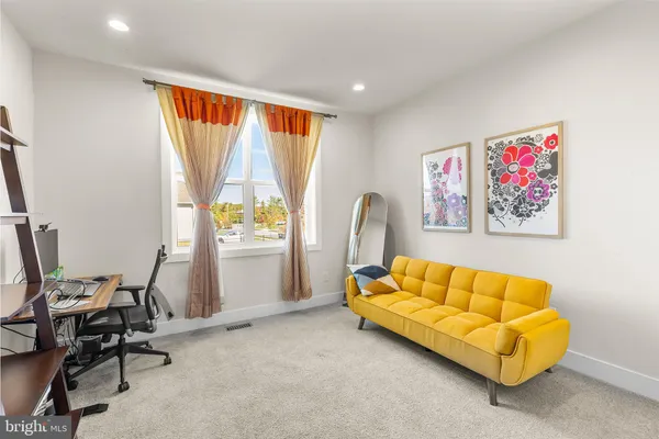 a workspace with lounge chair and a window