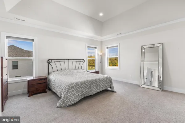 a spacious bedroom with a bed and a window