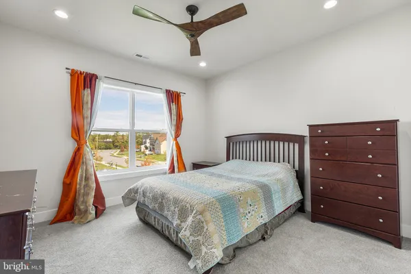 a bedroom with a bed next to a window