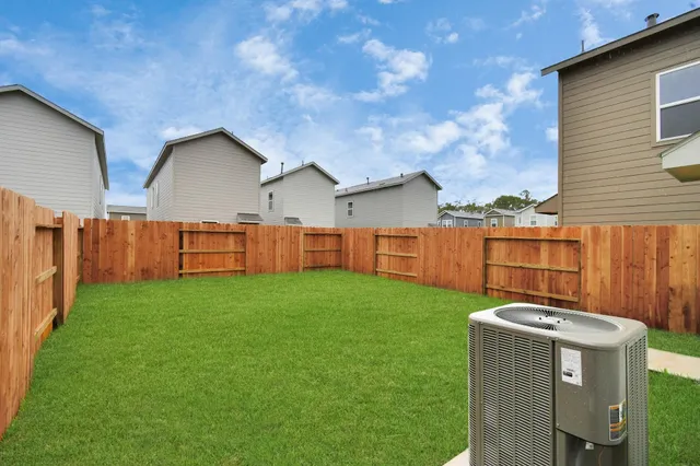 a view of a backyard with wooden fence