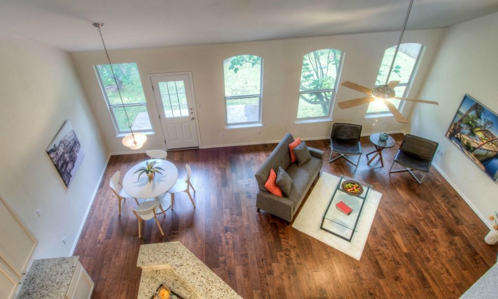 14813 Jacks Pond Road Austin, TX 78728 - Photo 12 of 29 Spacious open-concept room featuring high ceilings, wood-finish flooring, and multiple arched windows