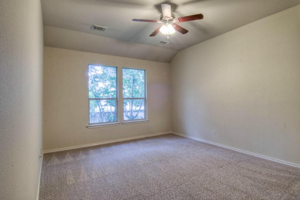 14813 Jacks Pond Road Austin, TX 78728 - Photo 19 of 29 Carpeted room featuring two windows, a ceiling fan with integrated lighting, and neutral wall tones
