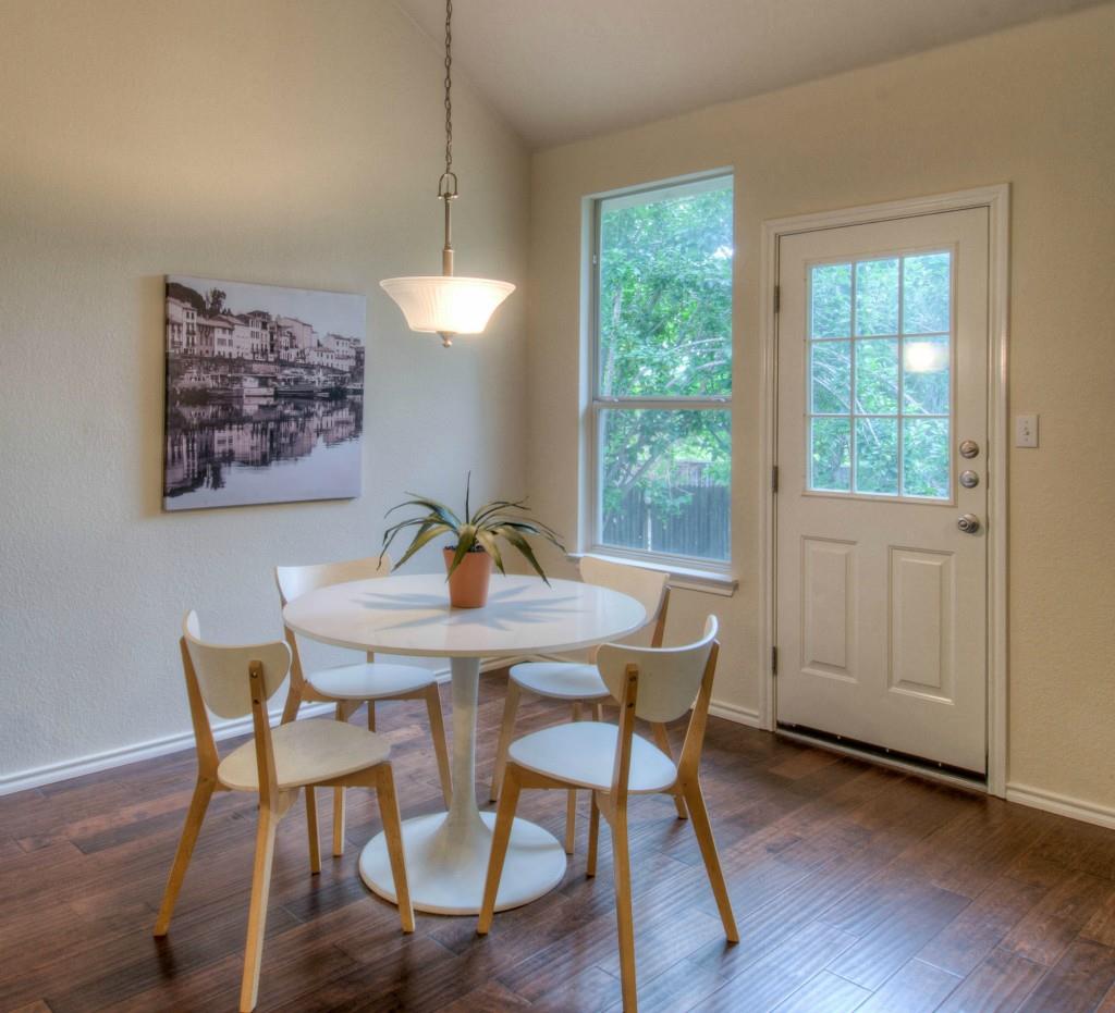 14813 Jacks Pond Road Austin, TX 78728 - Photo 23 of 29 Dining area featuring wood-finish flooring, a vaulted ceiling, and a suspended ceiling fixture