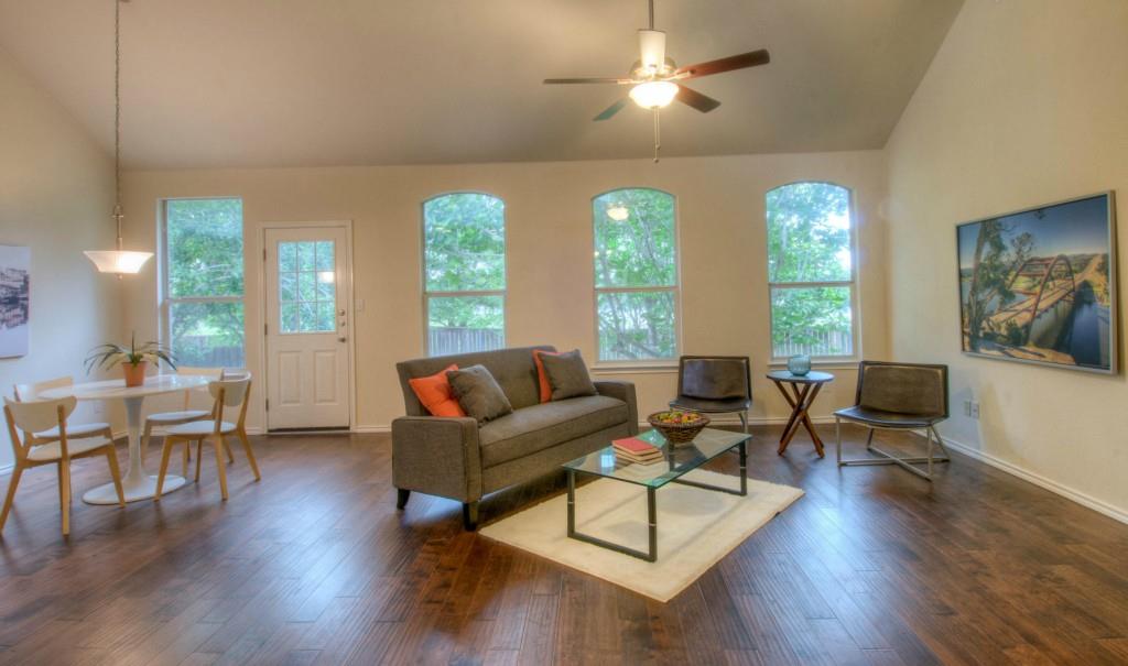 14813 Jacks Pond Road Austin, TX 78728 - Photo 26 of 29 Spacious living area featuring wood-finish flooring, vaulted ceilings, and a ceiling fan