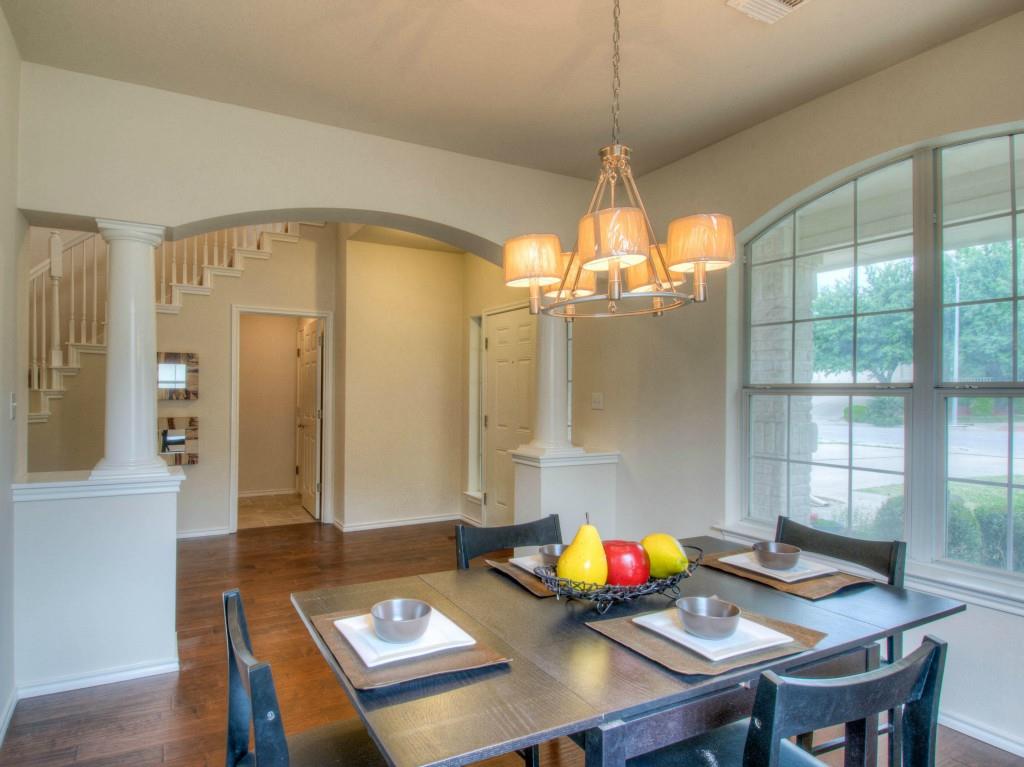 14813 Jacks Pond Road Austin, TX 78728 - Photo 28 of 29 Formal dining area featuring wood-finish flooring, a contemporary chandelier, and an arched window