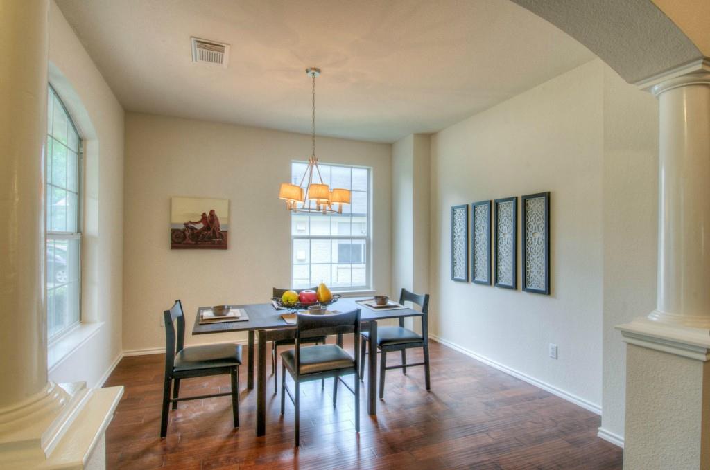 14813 Jacks Pond Road Austin, TX 78728 - Photo 29 of 29 Dedicated dining space featuring wood-finish flooring, an arched entryway, and multiple windows providing natural light