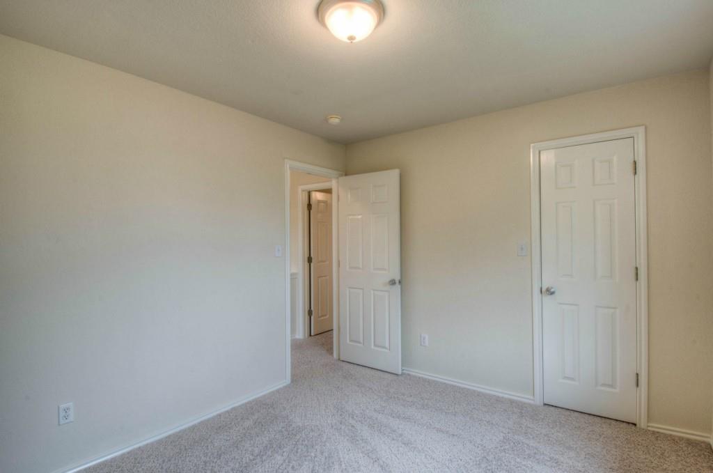 14813 Jacks Pond Road Austin, TX 78728 - Photo 5 of 29 Carpeted room featuring neutral wall tones, white trim, and white paneled doors