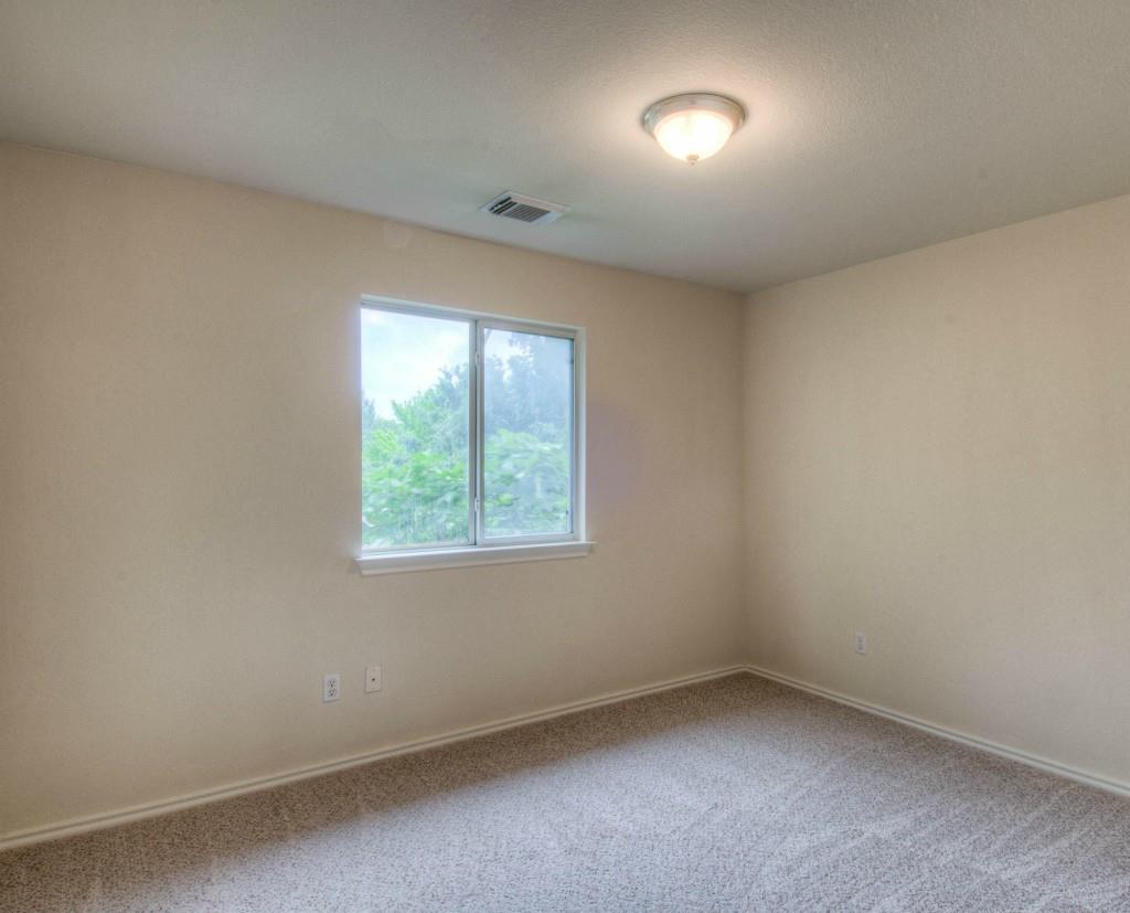 14813 Jacks Pond Road Austin, TX 78728 - Photo 6 of 29 Neutral-toned walls and carpeting create a versatile interior