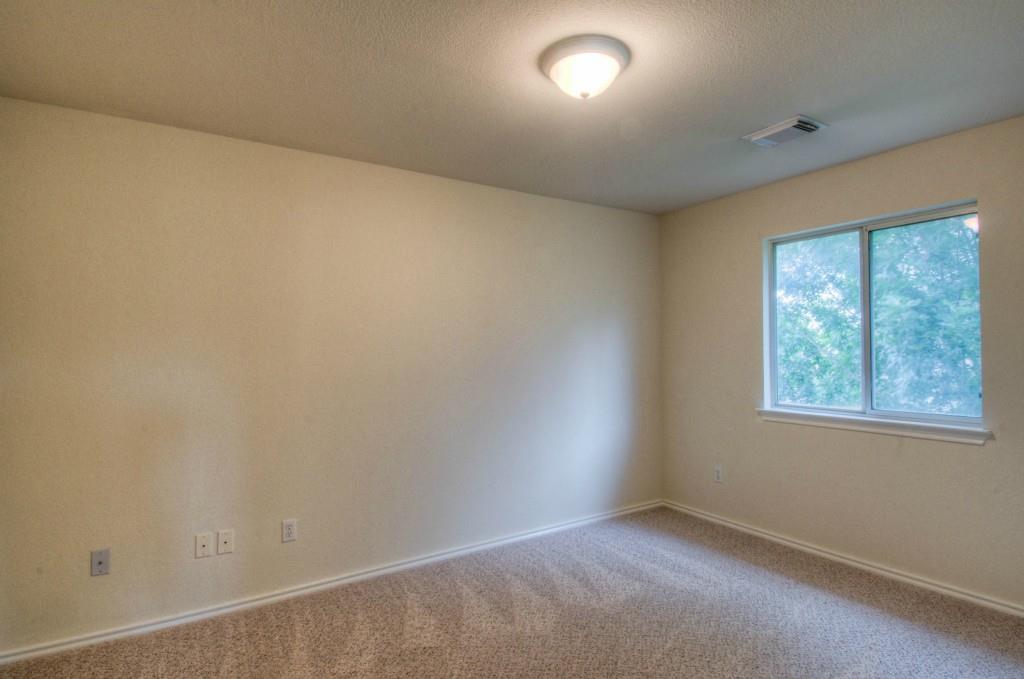 14813 Jacks Pond Road Austin, TX 78728 - Photo 8 of 29 Carpeted room featuring neutral-toned walls, a double-pane window, and a flush-mount ceiling light fixture
