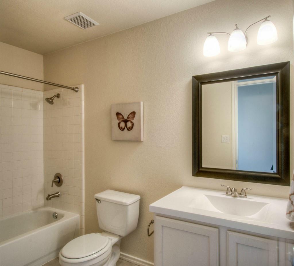 14813 Jacks Pond Road Austin, TX 78728 - Photo 9 of 29 Bathroom featuring a white vanity with integrated sink, brushed nickel faucet, and a large framed mirror
