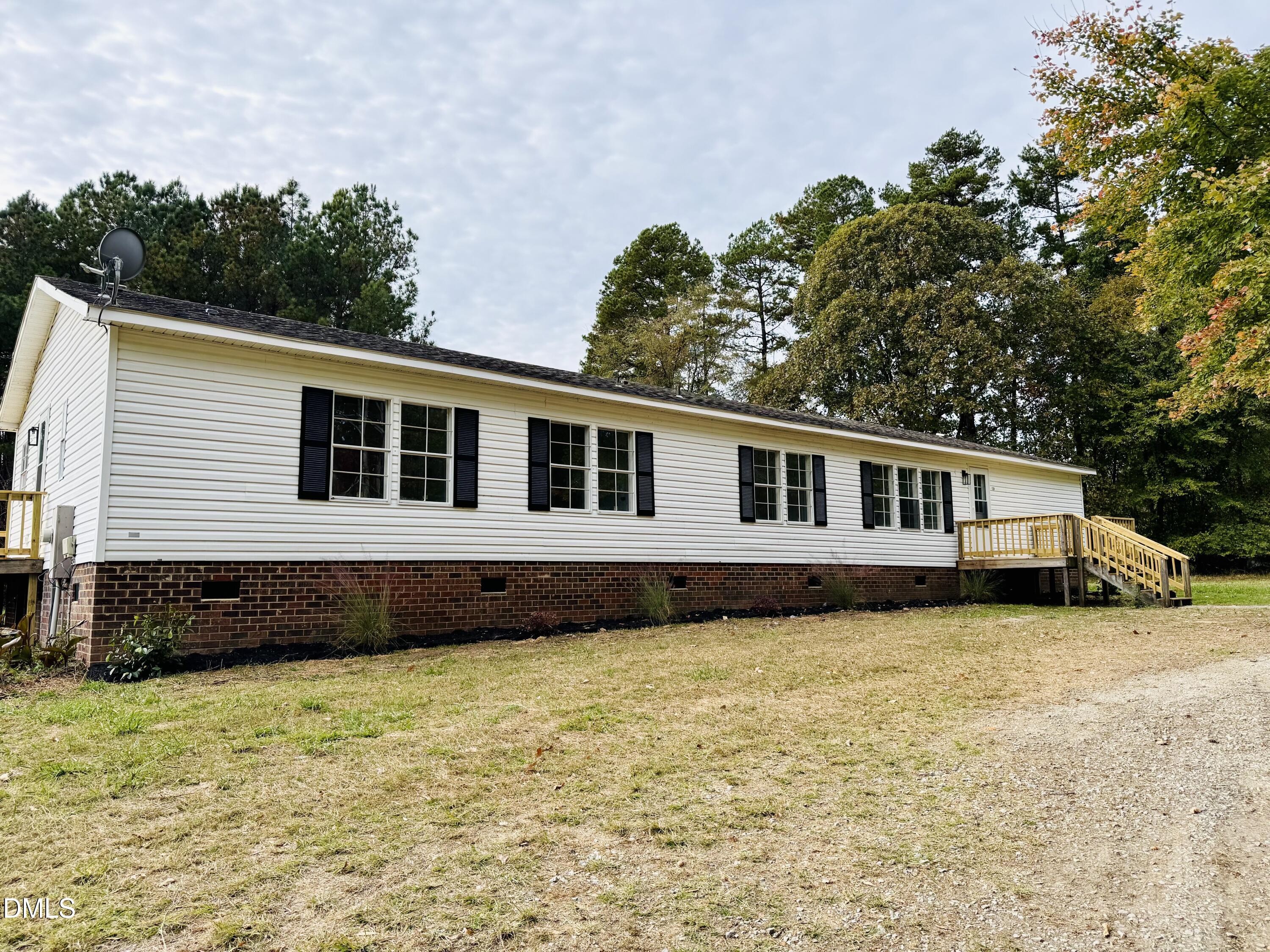 128 Lisa Cheryl Lane Roxboro, NC 27573 - Photo 1 of 23 a house that has a big yard with wooden fence