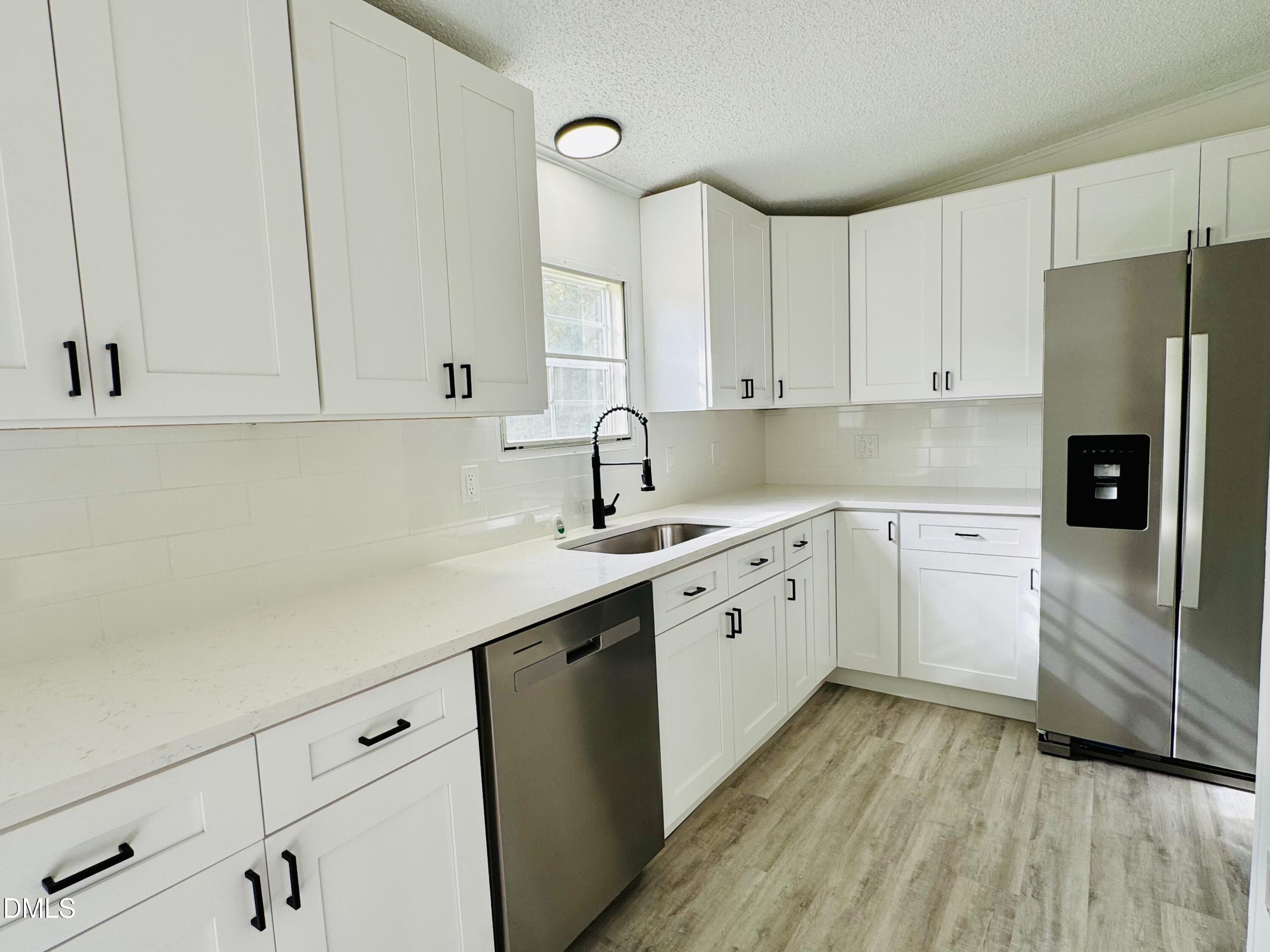 128 Lisa Cheryl Lane Roxboro, NC 27573 - Photo 11 of 23 a kitchen with granite countertop white cabinets and white appliances