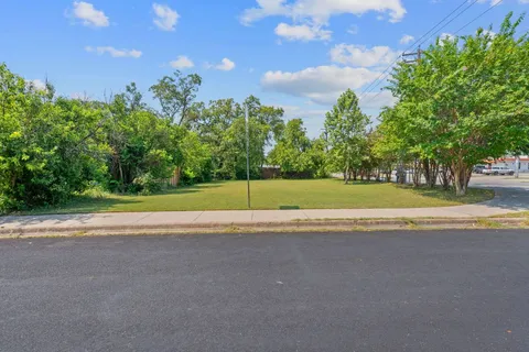 a view of a field with an trees