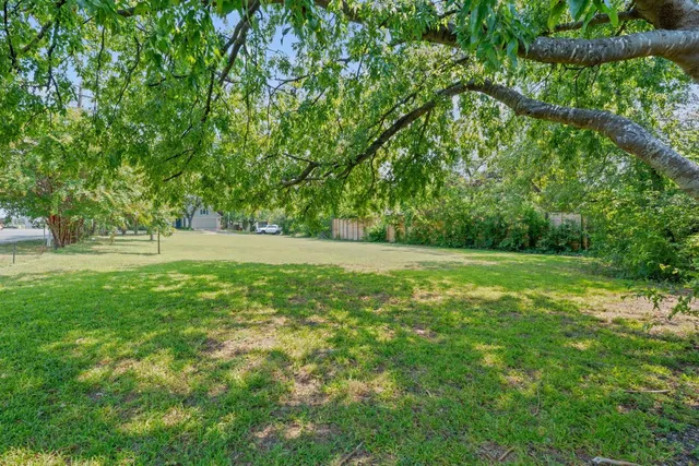 an aerial view of a house with a yard and lake view
