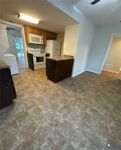 a kitchen with refrigerator and window